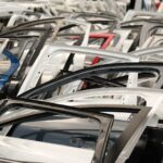 colorful array of car doors in a junkyard