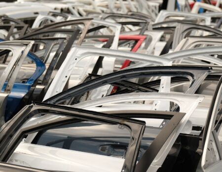 colorful array of car doors in a junkyard